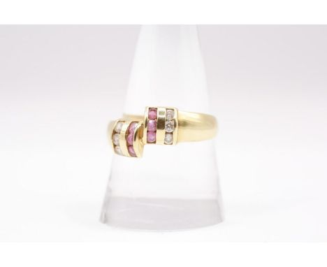 A ruby and cubic zirconia set dress ring in unmarked yellow metal. Gross weight approximately 4.0 grams. Size U. (1)