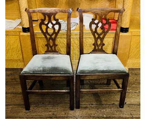 A pair of George III elm dining chairs, in a Thomas Chippendale manner, urn cresting splat, stuffed seat inlay, raised on rec