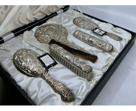 Two cased 1970s sterling silver hairbrush vanity sets by Broadway, in leather cases, comprising hair brushes, clothes brushes