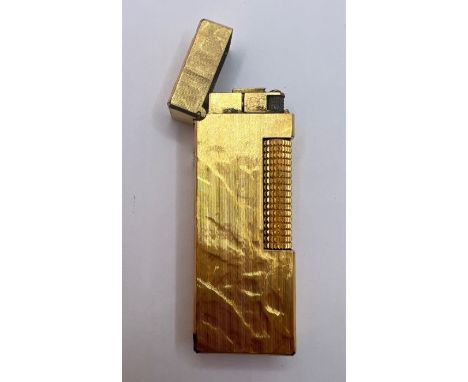A textured yellow metal Dunhill lighter. (1)