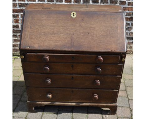 Georgian oak bureau with replacement knobs on bracket feet