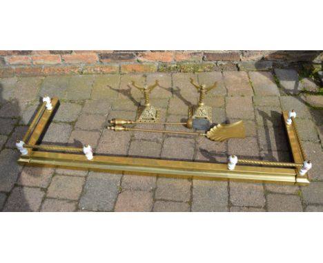 Brass fender, fire dogs and tools