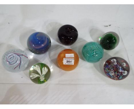 Eight glass dome paperweights to include signed paperweights. Also included in the lot is a Caithness Myriad # M48673, Caithn