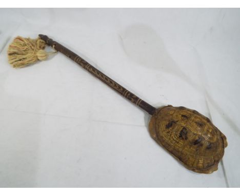 Tribal Art - a tribal musical string instrument made with a tortoise shell on a carved wooden handle This lot MUST be paid fo