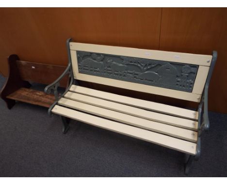 A cast iron and wood child's garden bench 52cm (h) x 83cm (l) x 34cm (w) and an oak bookshelf This lot MUST be paid for and c