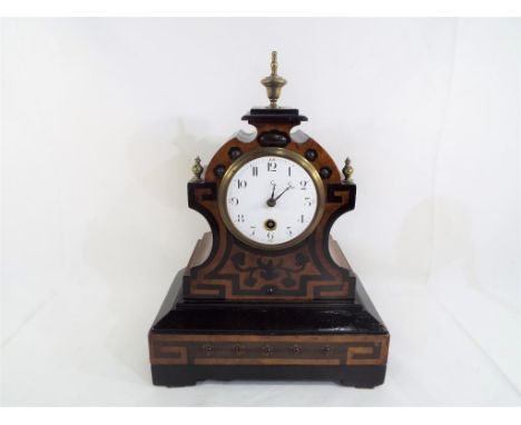 An unusual French mantel clock with inlaid Arts & Crafts style decoration, brass finials, time only movement by Japy Freres, 