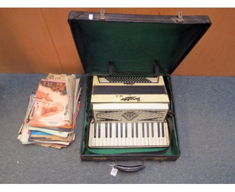 A cased Italian Geraldo standard accordion 80-2 and quantity of sheet music  This lot MUST be paid for and collected, or deli