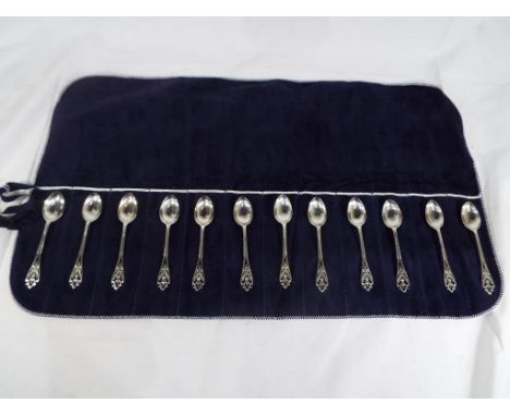 A set of twelve silver George V hallmarked teaspoons, Sheffield assay with pierced decoration depicting a thistle contained i