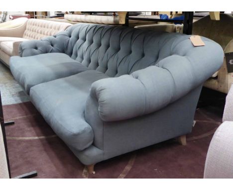 LOAF SOFA, in a buttoned blue fabric, 235cm W x 81cm H.