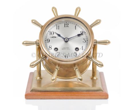 A 20TH CENTURY SHIP'S BELL DESK CLOCK BY CHELSEA the 3½in. silvered dial signed as per title with s/f wheel, strike-silent le