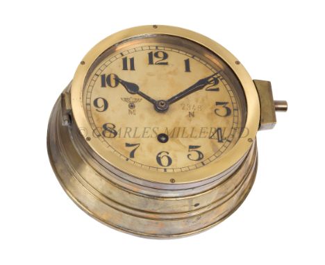 A KRIEGSMARINE U-BOAT BULKHEAD CLOCKthe 6in. polished brass dial marked with Kriegsmarine device numbered 7348 / N, black spa