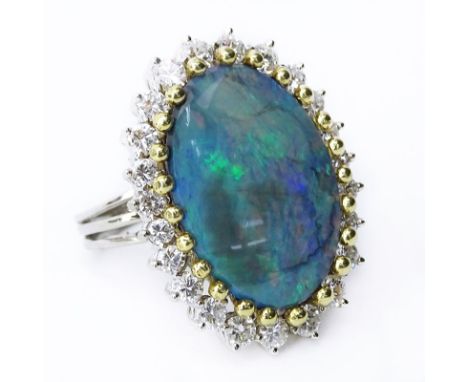 Approx. 9.0 Carat Oval Opal, 2.0 Carat Round Brilliant Cut Diamond and 18 Karat White and Yellow Gold Ring. Opal with good pl