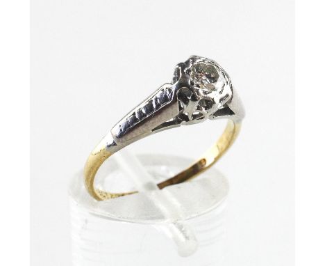 A yellow and white metal ring. Illusion set with a round brilliant cut diamond estimated to weigh 0.25cts. Stamped 18ct &amp;