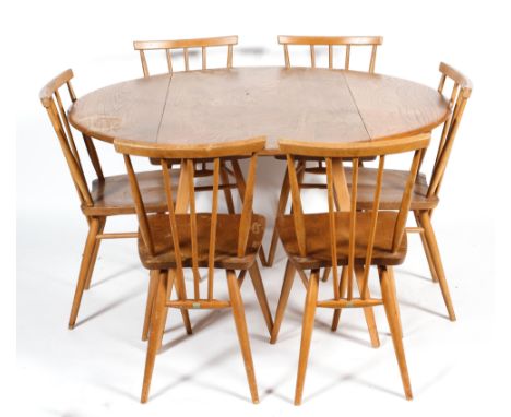 An Ercol elm and beech  circular folding dining-table and six spindle back dining chairs, 104 cm wide x 71 cm high, the chair