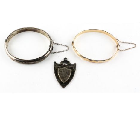 A collection of jewellery to include: A sterling silver shield pendant with personal presentation message; A sterling silver 
