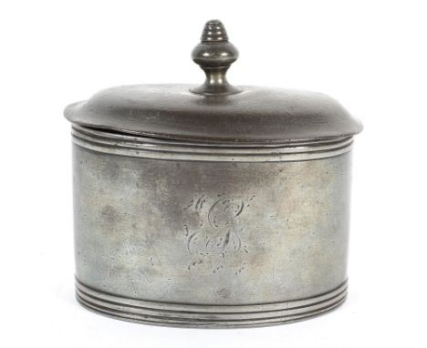 A Georgian pewter tea caddy of oval form, with original press to interior, engraved with indistinct monogram within reeded bo
