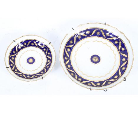 A Worcester spirally-fluted saucer-dish and a saucer, late 18th century, blue crescent marks, painted with dark blue and gilt