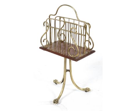 A brass and mahogany revolving magazine rack, on a tripod base, 82cm high x 41cm wide x 21cm deep