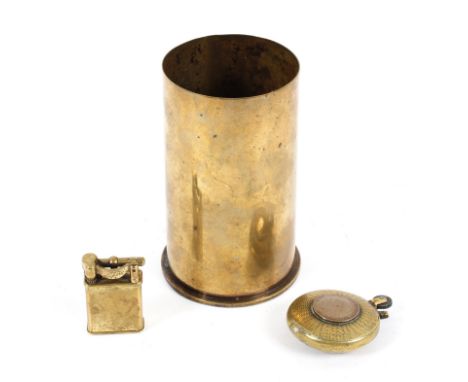 Two trench art lighters together with a brass shell case, the first lighter of circular form applied with a George V coin, th