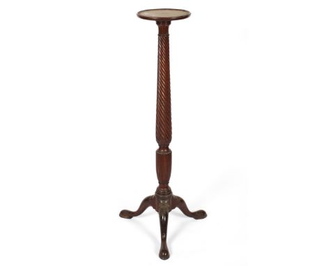 A George III style mahogany torchere stand, early 20th century, on spirally moulded baluster stem issuing tripod legs and pad