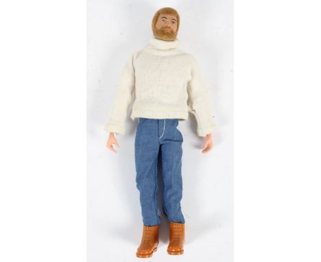 A vintage Action Man with blond hair and beard, in a roll neck sweater, jeans and boots