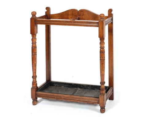 A Victorian oak umbrella/stick stand, with turned baluster uprights, with two divisions inset with metal drip-tray, 85 cm hig