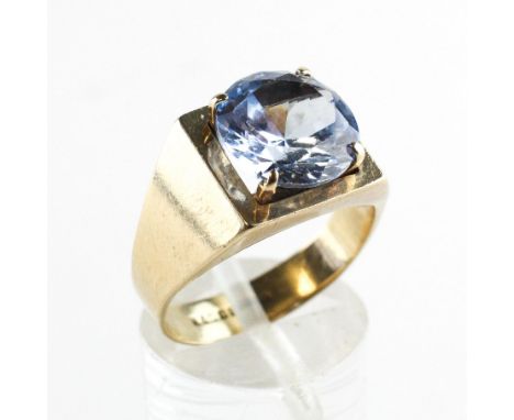 A yellow metal ring set with a 10mm round cut synthetic blue spinel. Hallmarked 9ct gold, Birmingham. Size N 5.0 grams