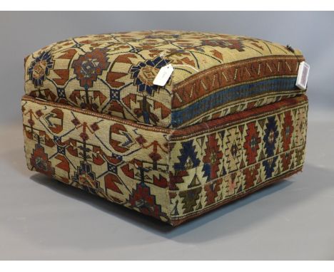 An Ottoman stool, upholstered with antique Russian carpet, raised on castors, H.40 W.61 D.55cm 