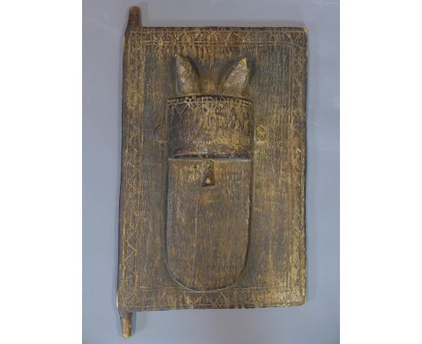 An antique African tribal art door panel, carved with a mask, possibly Dogon tribe, Mali, 52 x 34cm 