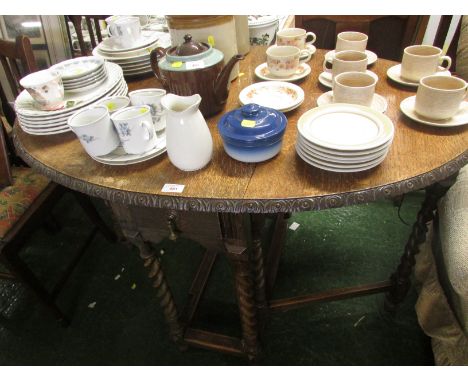 AN OAK OVAL DROP-LEAF GATE-LEG TABLE WITH SINGLE DRAWER, AND A SET OF FOUR MID WOOD FRAMED CHAIRS WITH DROP-IN SEATS