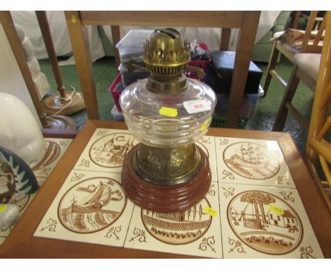 Glass bodied oil lamp on ceramic base.