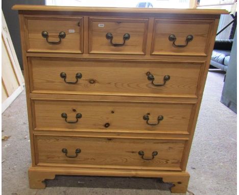 A stripped pine chest of three long and two short drawers with brass swan necked handles on bracket supports, 95 cm wide 