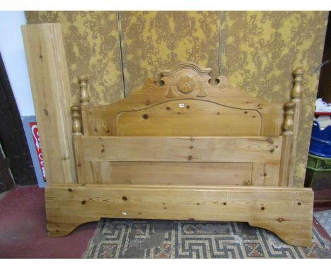 A stripped pine double bedstead with turned finials and arched and moulded headboard (complete with adjoining side rails and 