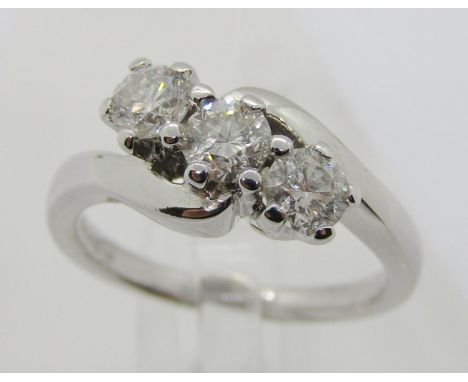 18ct white gold three stone diamond crossover ring, each stone 0.20ct approx, maker 'RG', size J/K, 4.6g, with Ernest Jones b