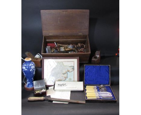 A battered old tin trunk, containing an old wooded tool box containing some oils tools, a blue and white vase, a box of fish 