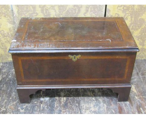 An antique walnut coffer with herringbone banding on bracket supports, 46cm high, 76cm x 43cm 
