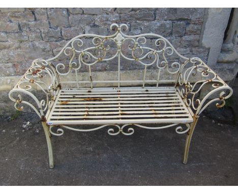 A decorative contemporary weathered painted light steel two seat garden bench with open scrollwork detail, strap work seat an