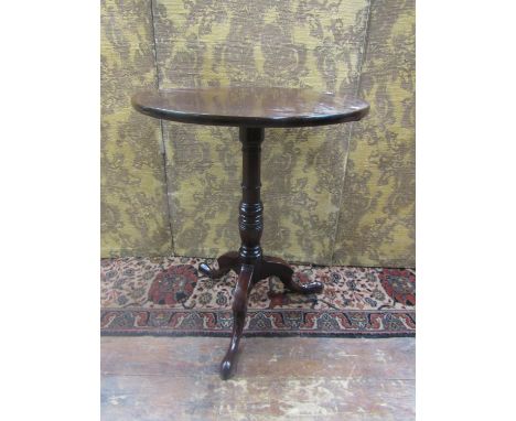 A Georgian mahogany snap top table with single piece top, raised on a turned pillar and tripod base, 72cm high, 58cm diameter