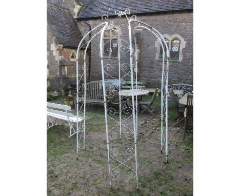 A painted light steel tubular framed sectional gazebo or arbour with simple repeating open scrollwork detail, together with a