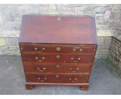 A Georgian oak bureau country made bureau, the fall flap enclosing a fitted interior over four long graduated drawers set on 
