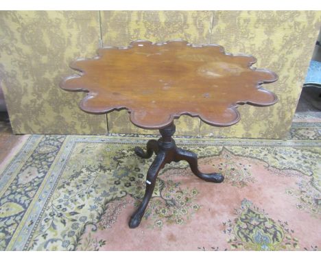 A George III mahogany supper table with shaped outline, raised on a turned and fluted column with carved tripod base, 70cm hi