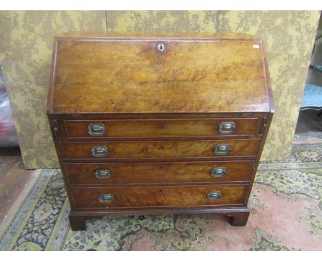 Georgian yew bureau of four long graduated drawers on bracket supports, the fall flap enclosing a fitted interior of drawers 