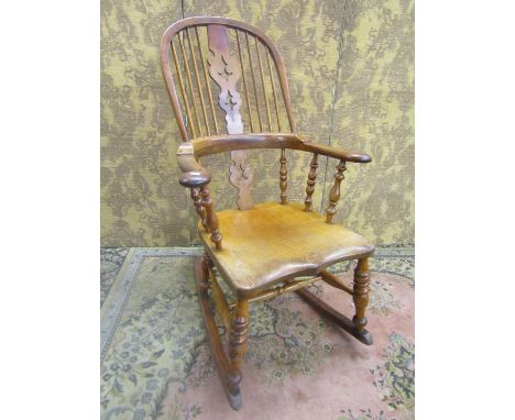 A 19th century comb back Windsor chair in mixed woods, elm, ash, etc, with pierced splat, stamped to undersides Alsop &amp; S