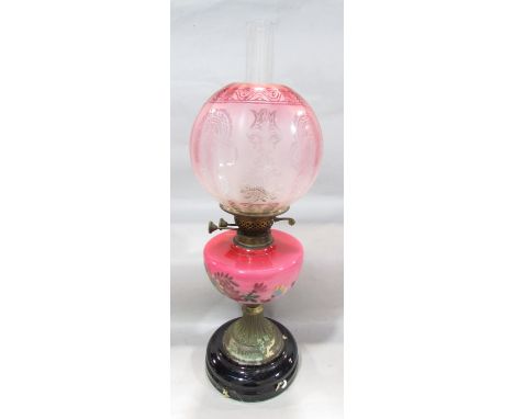 A Victorian oil lamp with a rose pink floral font and etched glass shade, 57cm 