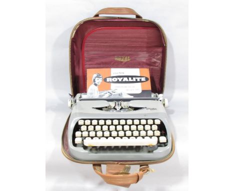 A Royalite portable typewriter circa 1960’s, made by Royal, in its original case and with instruction pamphlet. 
