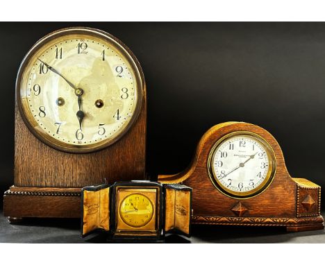 Oak mantle clock with two train striking movement, further example with carved and shaped oak case with enamelled dial and ei