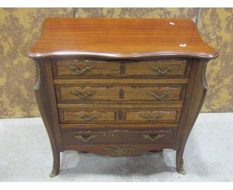 A drinks/cocktail cabinet in the form of a reproduction French commode with mock four drawer elevation with hinged lid, fall 
