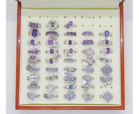 Collection of purple - violet gem set silver dress rings, to include amethyst, tanzanite, opal, quartz, iolite and topaz exam