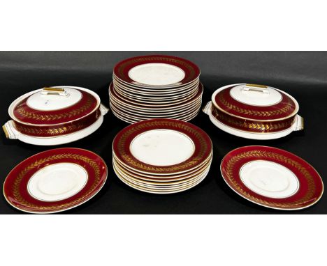 A Palissy Pottery dinner services for eight with red ground and gilt banded borders, comprising dinner plates, dessert plates