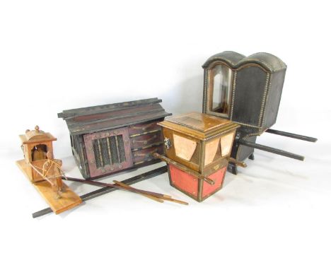 A black lacquered brass studded model of a sedan chair 25cm high, a wooded model of a sedan chair being carried, a trinket bo